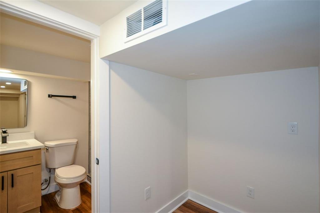 1275 Westridge Road Southwest Atlanta, GA 30311 - Photo 26 of 38 a white toilet sitting next to a bathroom sink