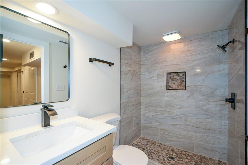 1275 Westridge Road Southwest Atlanta, GA 30311 - Photo 31 of 38 a bathroom with a sink toilet and shower