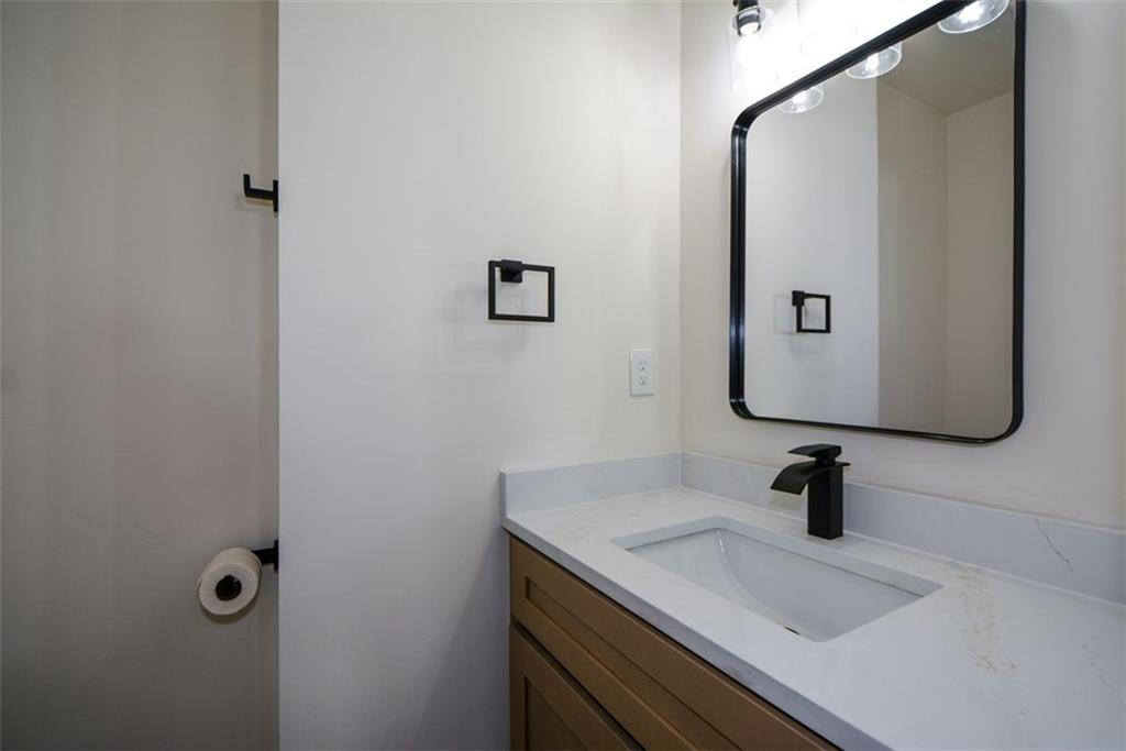 1275 Westridge Road Southwest Atlanta, GA 30311 - Photo 6 of 38 a bathroom with a sink and mirror