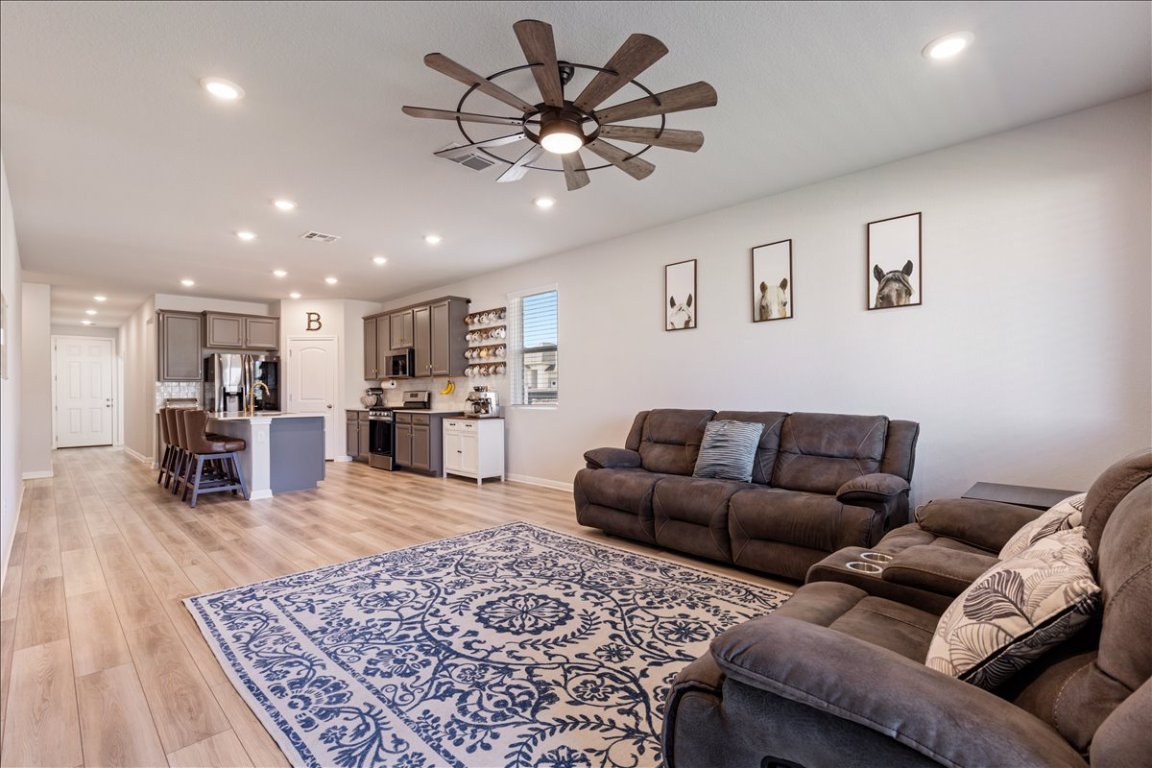 1001 A Dog Iron Street Georgetown, TX 78633 - Photo 9 of 25 a living room with furniture and kitchen view