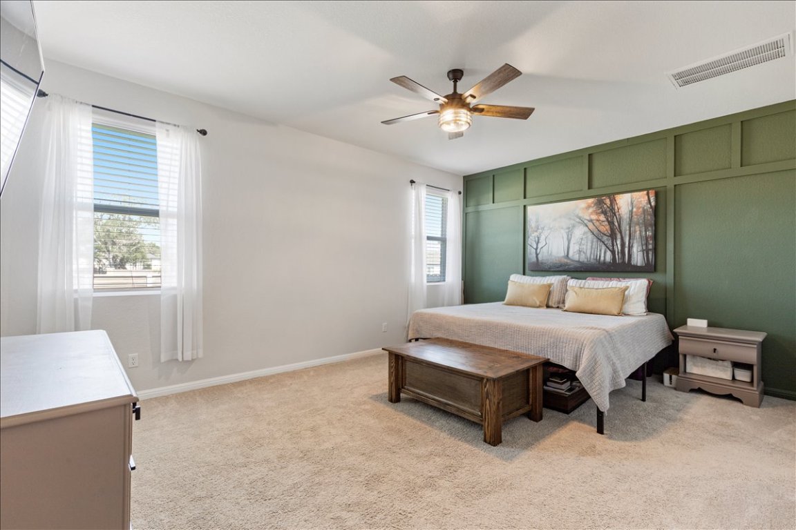 1001 A Dog Iron Street Georgetown, TX 78633 - Photo 10 of 25 a spacious bedroom with a bed and a chandelier