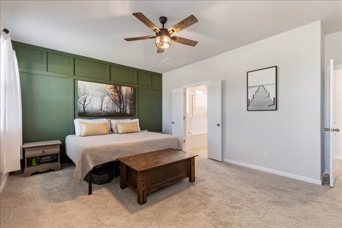 1001 A Dog Iron Street Georgetown, TX 78633 - Photo 11 of 25 a bedroom with a bed and a chandelier
