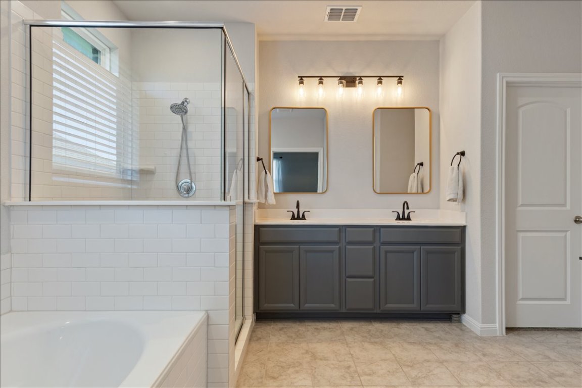 1001 A Dog Iron Street Georgetown, TX 78633 - Photo 14 of 25 a bathroom with a double vanity sink mirror and bathtub