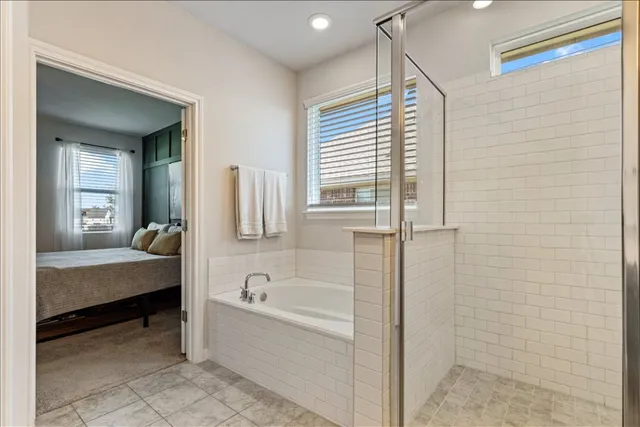 a bathroom with a double vanity sink mirror and bathtub