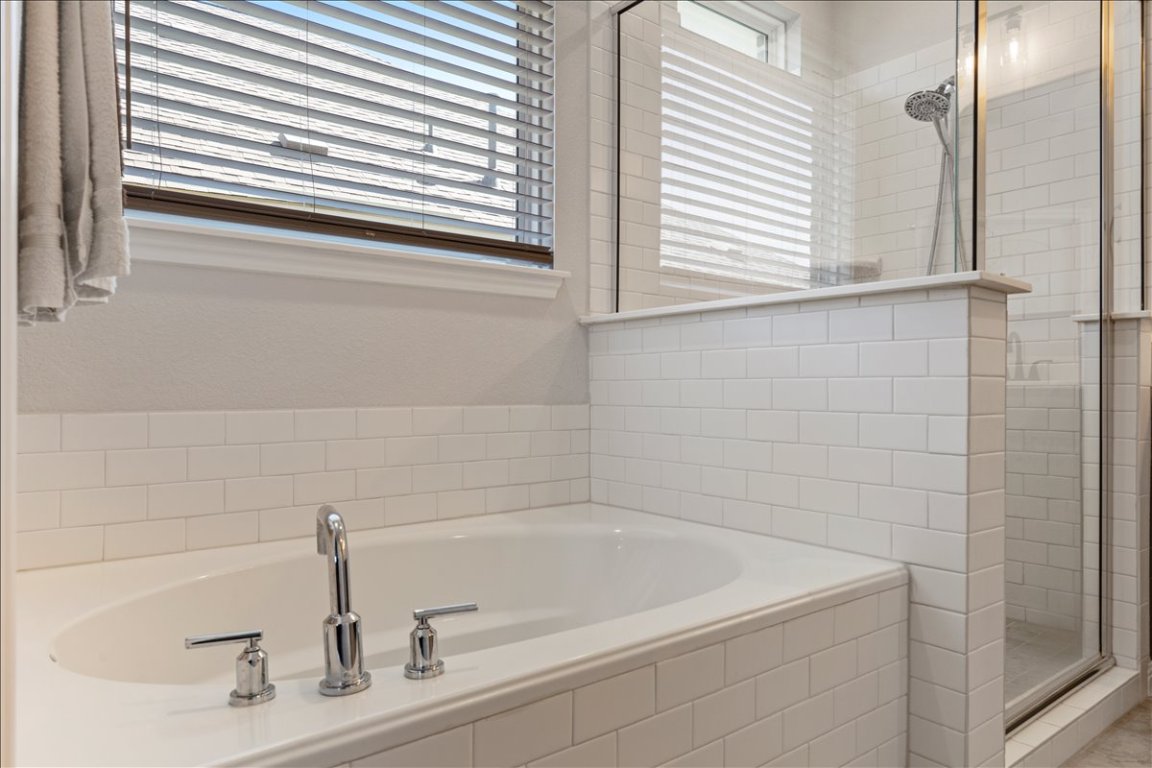 1001 A Dog Iron Street Georgetown, TX 78633 - Photo 16 of 25 a close view of a bathtub in a bathroom
