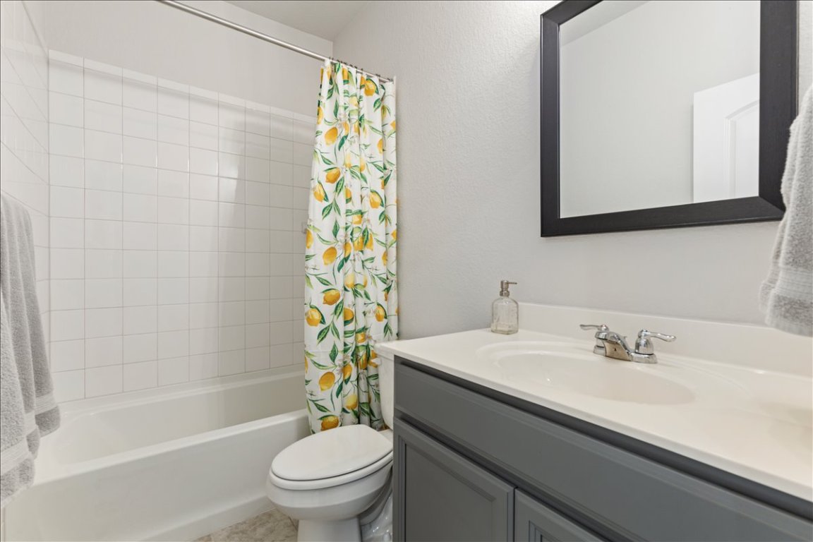 1001 A Dog Iron Street Georgetown, TX 78633 - Photo 17 of 25 a bathroom with a sink a toilet and a mirror