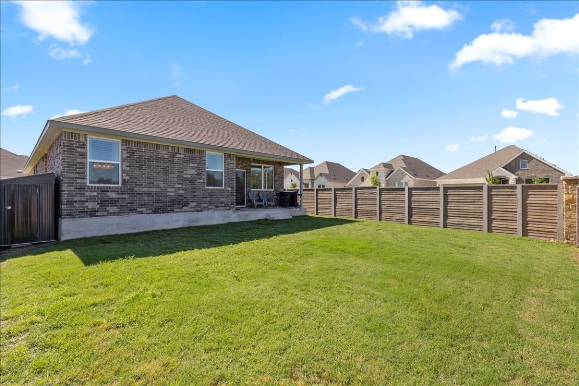 1001 A Dog Iron Street Georgetown, TX 78633 - Photo 21 of 25 a view of a house with a yard and sitting area