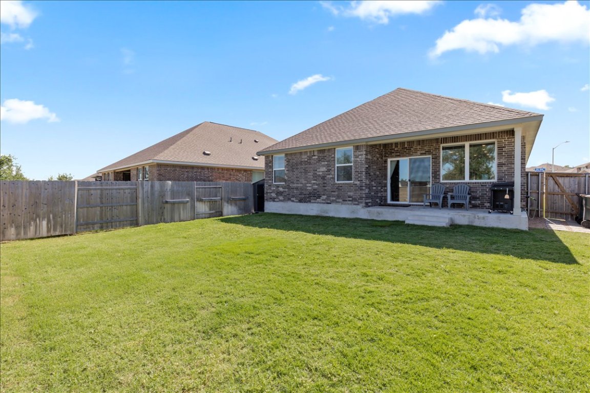 1001 A Dog Iron Street Georgetown, TX 78633 - Photo 22 of 25 a front view of house with a garden and patio
