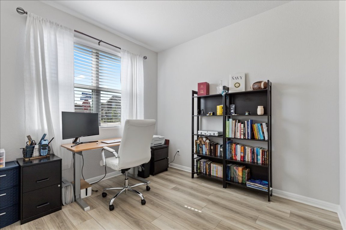 1001 A Dog Iron Street Georgetown, TX 78633 - Photo 3 of 25 a view of a workspace with furniture and a window