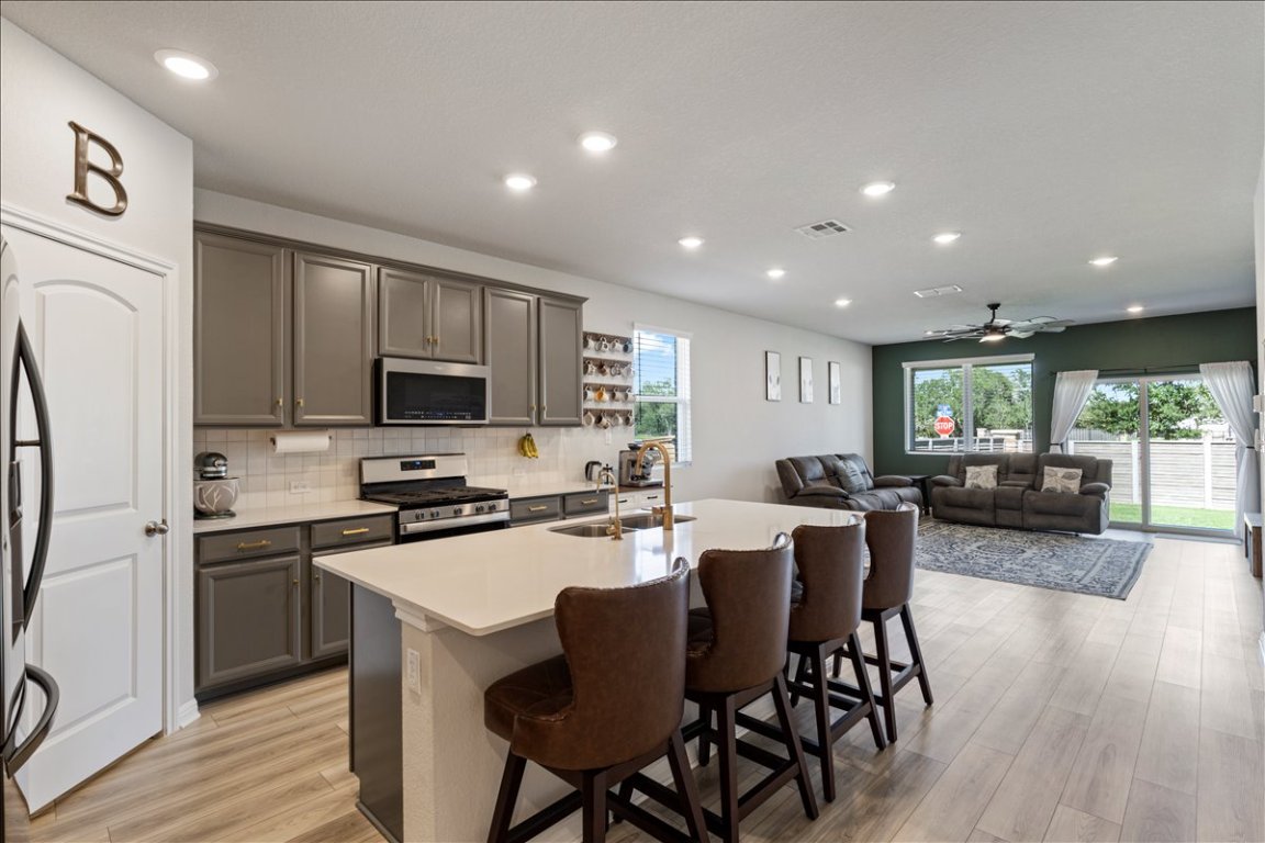 1001 A Dog Iron Street Georgetown, TX 78633 - Photo 5 of 25 a view of a dining room with furniture a kitchen and chandelier
