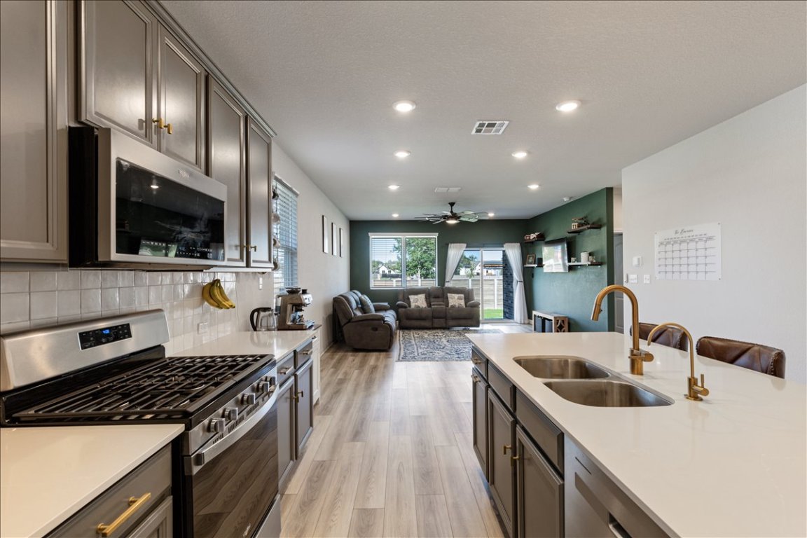 1001 A Dog Iron Street Georgetown, TX 78633 - Photo 25 of 25 a kitchen with kitchen island a sink stove top oven and refrigerator