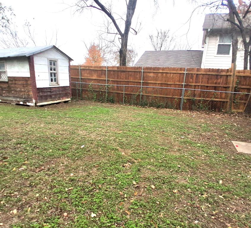 820 Allen Street Denton, TX 76205 - Photo 13 of 14 a view of a backyard with wooden fence and a large tree