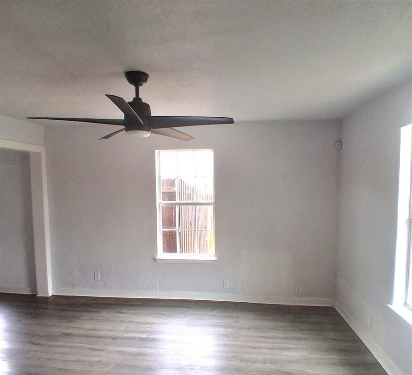 820 Allen Street Denton, TX 76205 - Photo 3 of 14 a view of empty room with wooden floor and fan