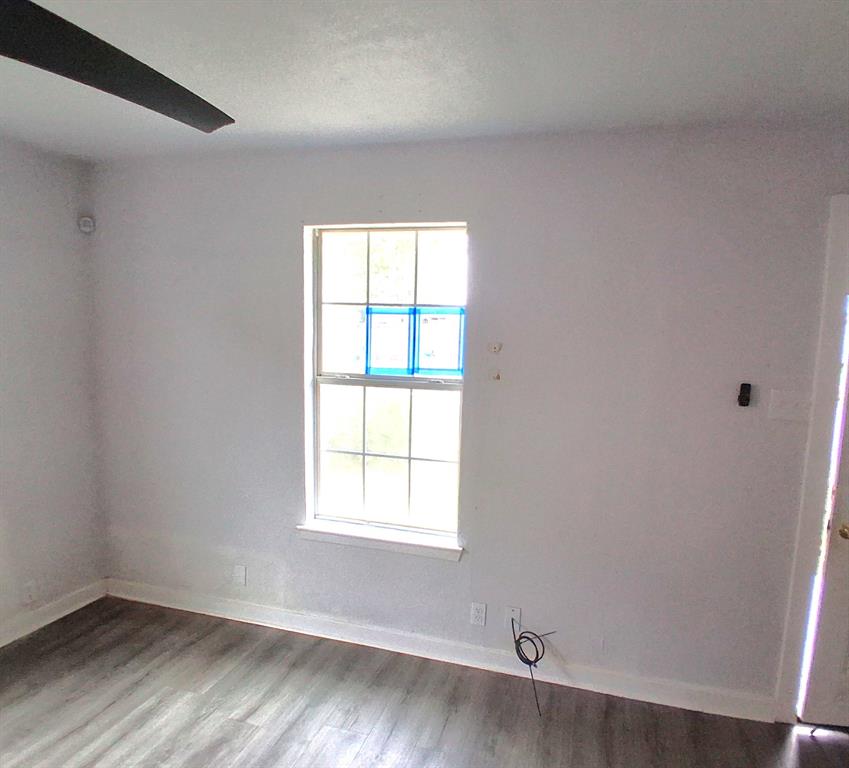 820 Allen Street Denton, TX 76205 - Photo 6 of 14 an empty room with wooden floor and windows