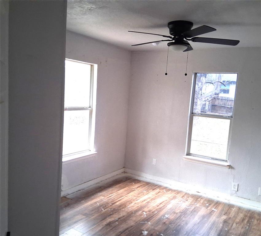 820 Allen Street Denton, TX 76205 - Photo 8 of 14 an empty room with windows and fan