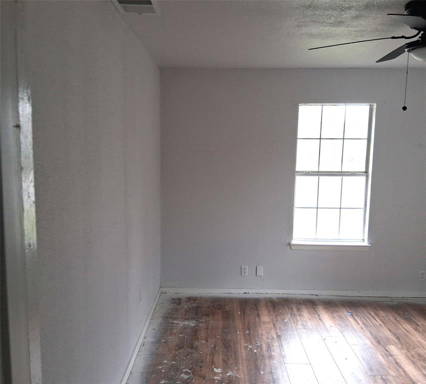 820 Allen Street Denton, TX 76205 - Photo 9 of 14 an empty room with wooden floor and windows