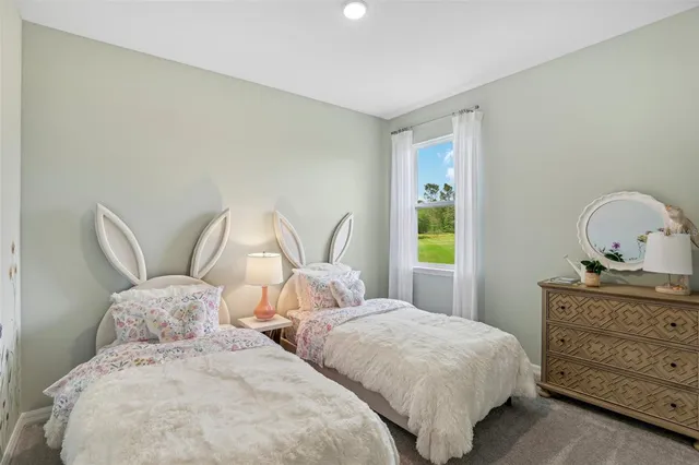 a bedroom with two beds and a dresser