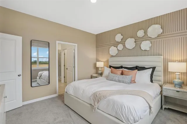 a bedroom with a large bed and a chandelier