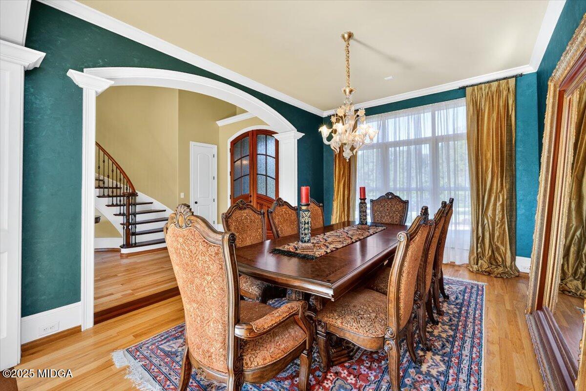 208 Crystal Drive Byron, GA 31008 - Photo 23 of 87 a dining room with furniture a chandelier and wooden floor