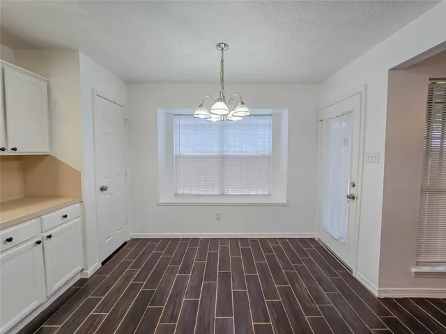 a view of a room with wooden floor cabinets and a window