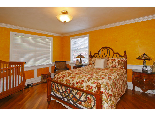 9 Ashdown Place Half Moon Bay, CA 94019 - Photo 17 of 21 a bedroom with a bed a dresser with wooden floor