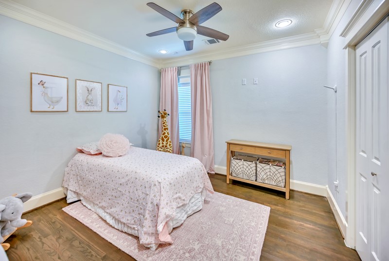 1122 East 23rd Street Houston, TX 77009 - Photo 14 of 23 Charming secondary bedroom with hardwood floors, crown molding, and abundant natural light.