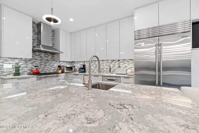 a kitchen with stainless steel appliances granite countertop a sink stove and cabinets