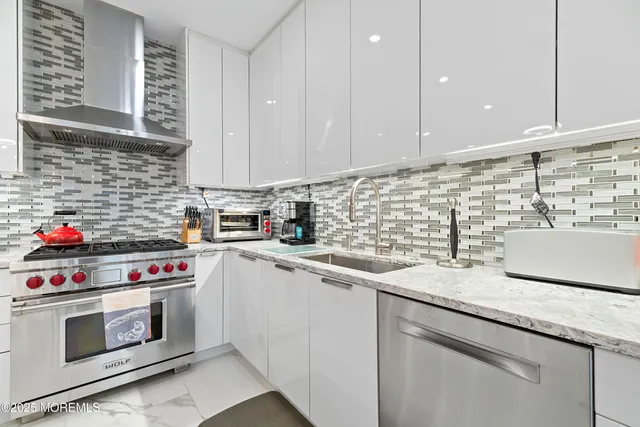 a kitchen with white cabinets and white appliances