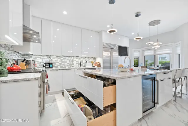 a kitchen with refrigerator and cabinets
