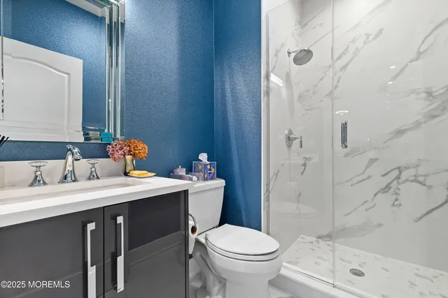 a hallway with a book shelf and wooden floor