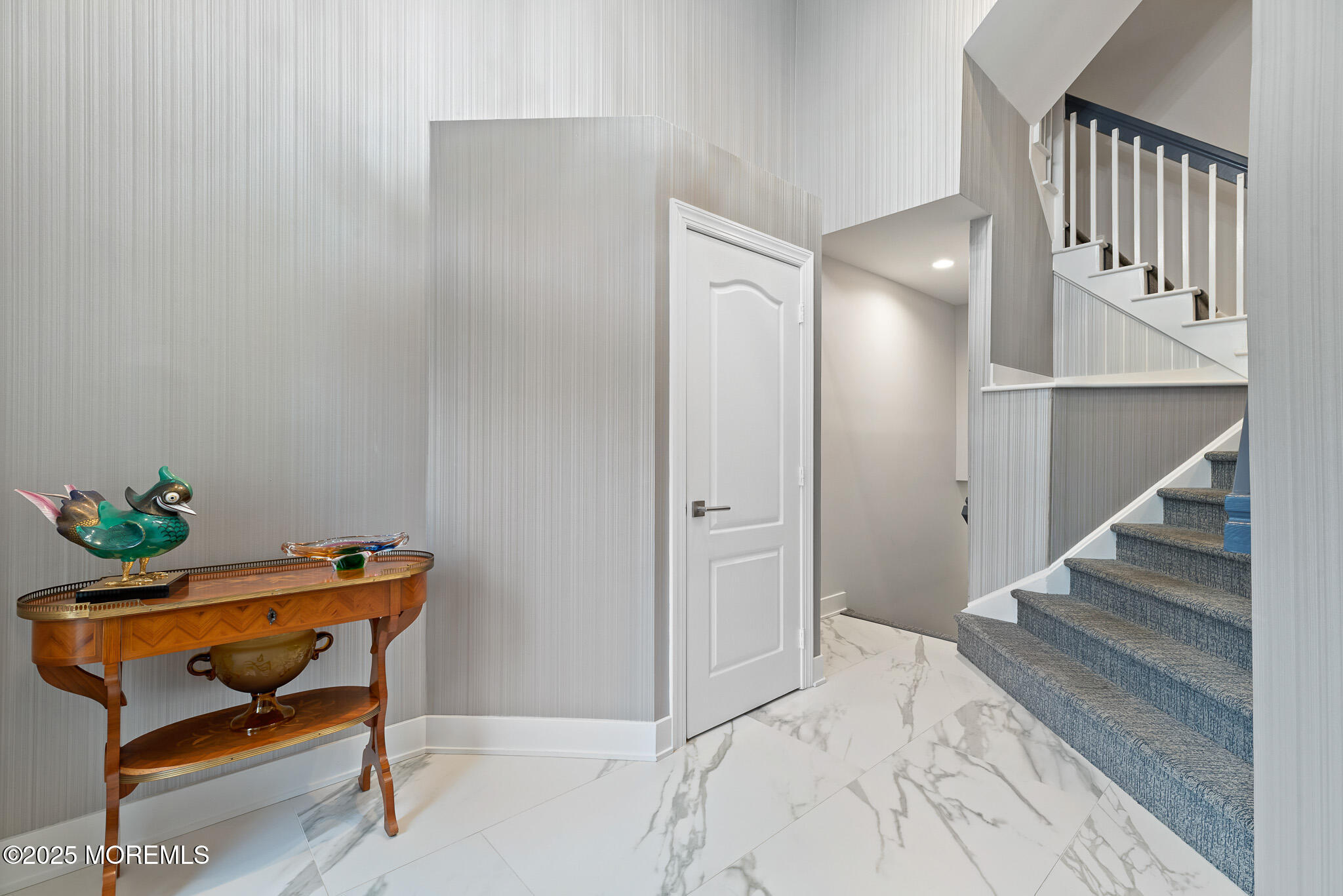 17 Riviera Drive Long Branch, NJ 07740 - Photo 24 of 52 a hallway with a book shelf and wooden floor