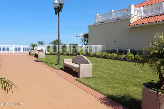 a swimming pool with outdoor seating and a garden
