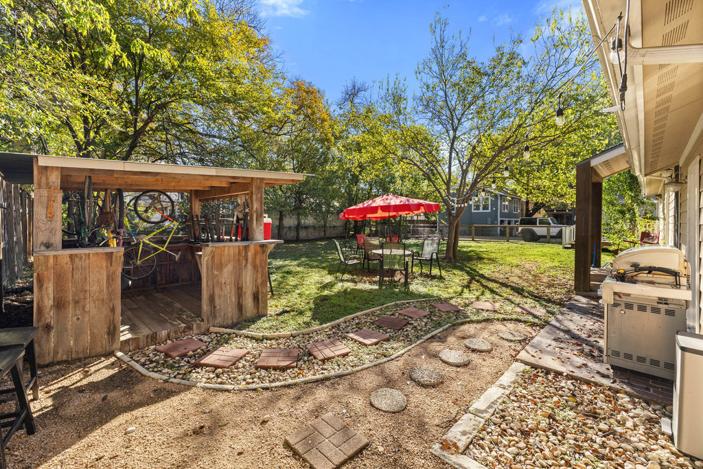 1221 South Austin Avenue Georgetown, TX 78626 - Photo 15 of 19 a view of a patio with table and chairs potted plants and large tree