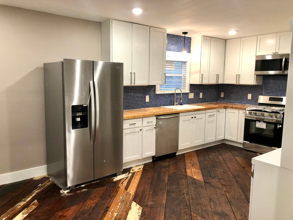 1221 South Austin Avenue Georgetown, TX 78626 - Photo 5 of 19 a large kitchen with stainless steel appliances granite countertop a stove a sink and a refrigerator