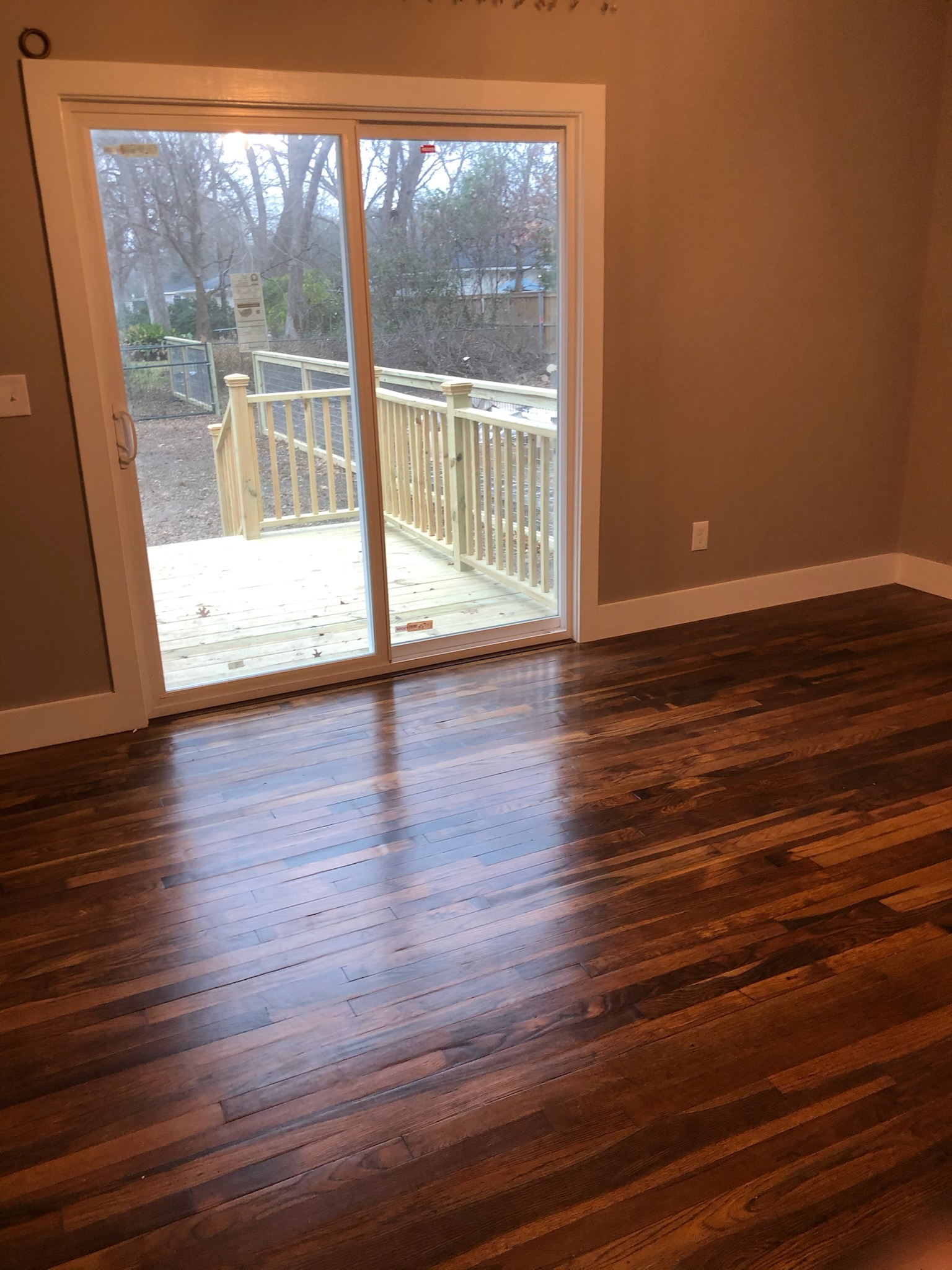 1221 South Austin Avenue Georgetown, TX 78626 - Photo 7 of 19 a view of an empty room with wooden floor and a window