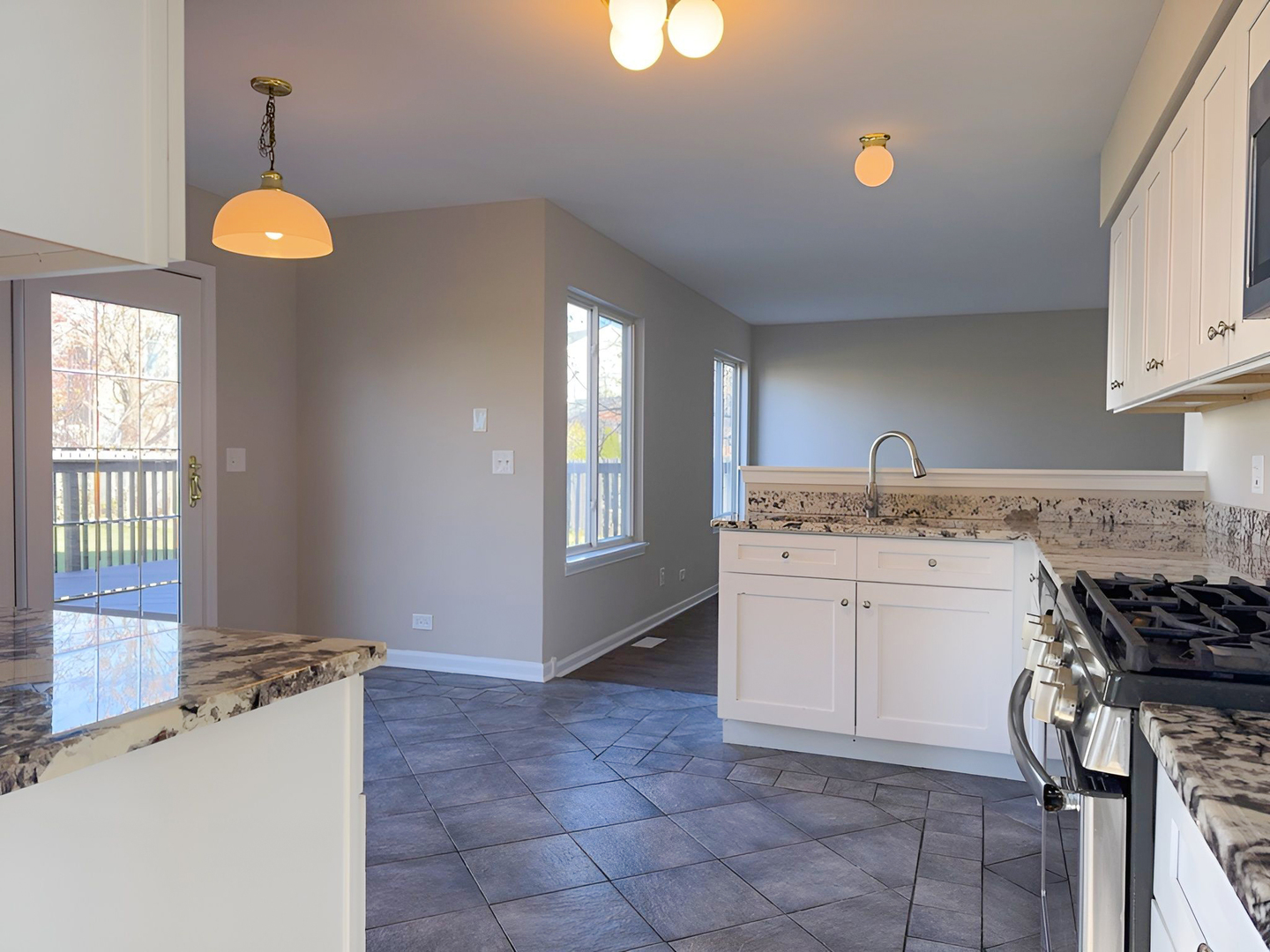 1183 Moonstone Run Lake In The Hills, IL 60156 - Photo 15 of 41 a kitchen with a stove a sink a window and dining table