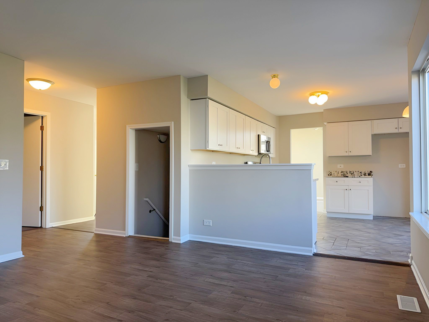 1183 Moonstone Run Lake In The Hills, IL 60156 - Photo 17 of 41 a view of a kitchen with wooden floor and a refrigerator
