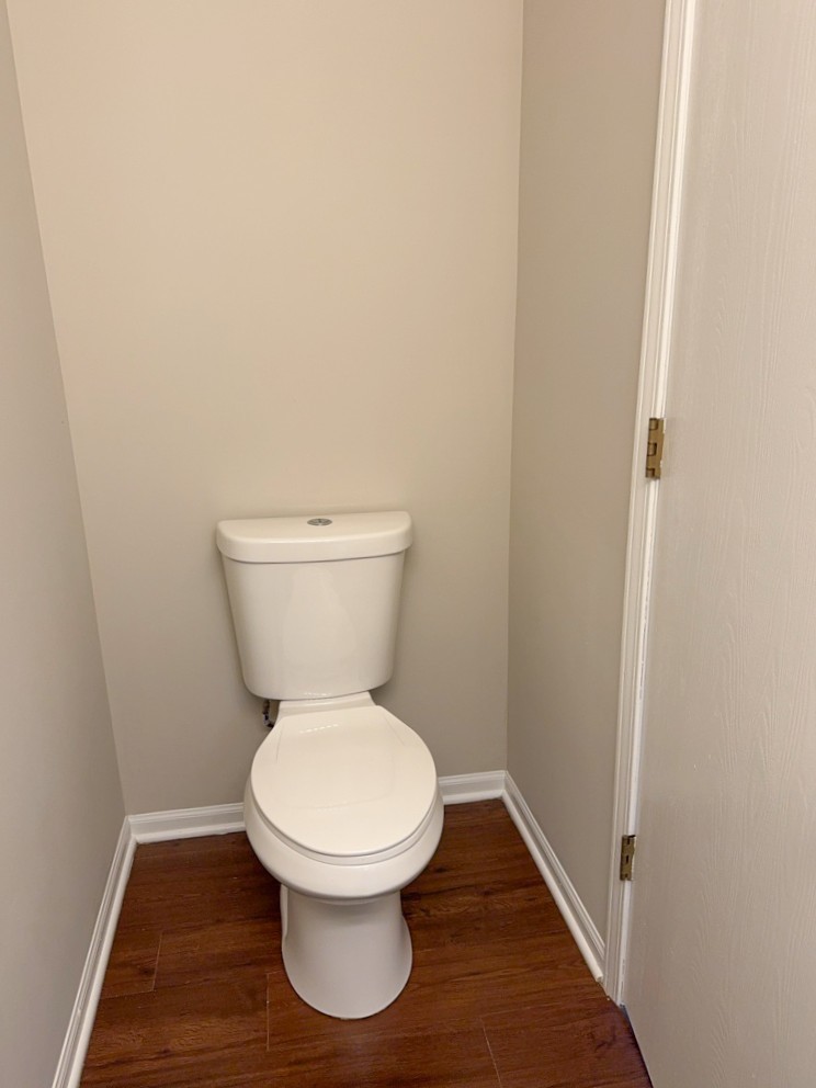 1183 Moonstone Run Lake In The Hills, IL 60156 - Photo 19 of 41 a white toilet sitting in a bathroom next to a wooden wall