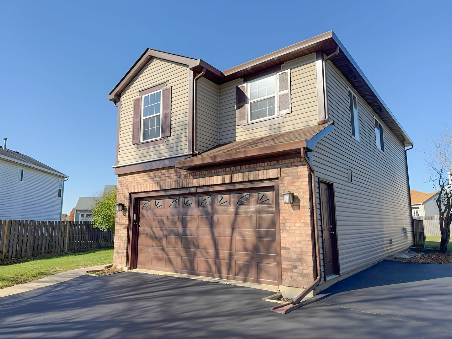1183 Moonstone Run Lake In The Hills, IL 60156 - Photo 2 of 41 a front view of a house with a wooden fence