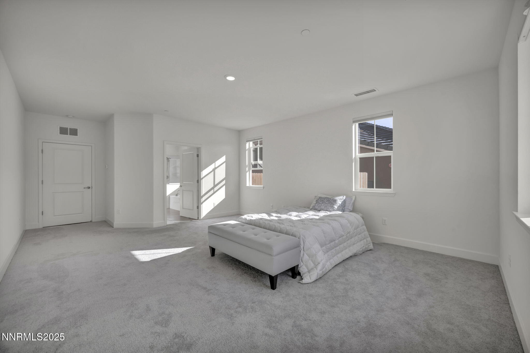 6870 Pilot Peak Road Sparks, NV 89436 - Photo 11 of 55 a spacious bedroom with a bed and a window