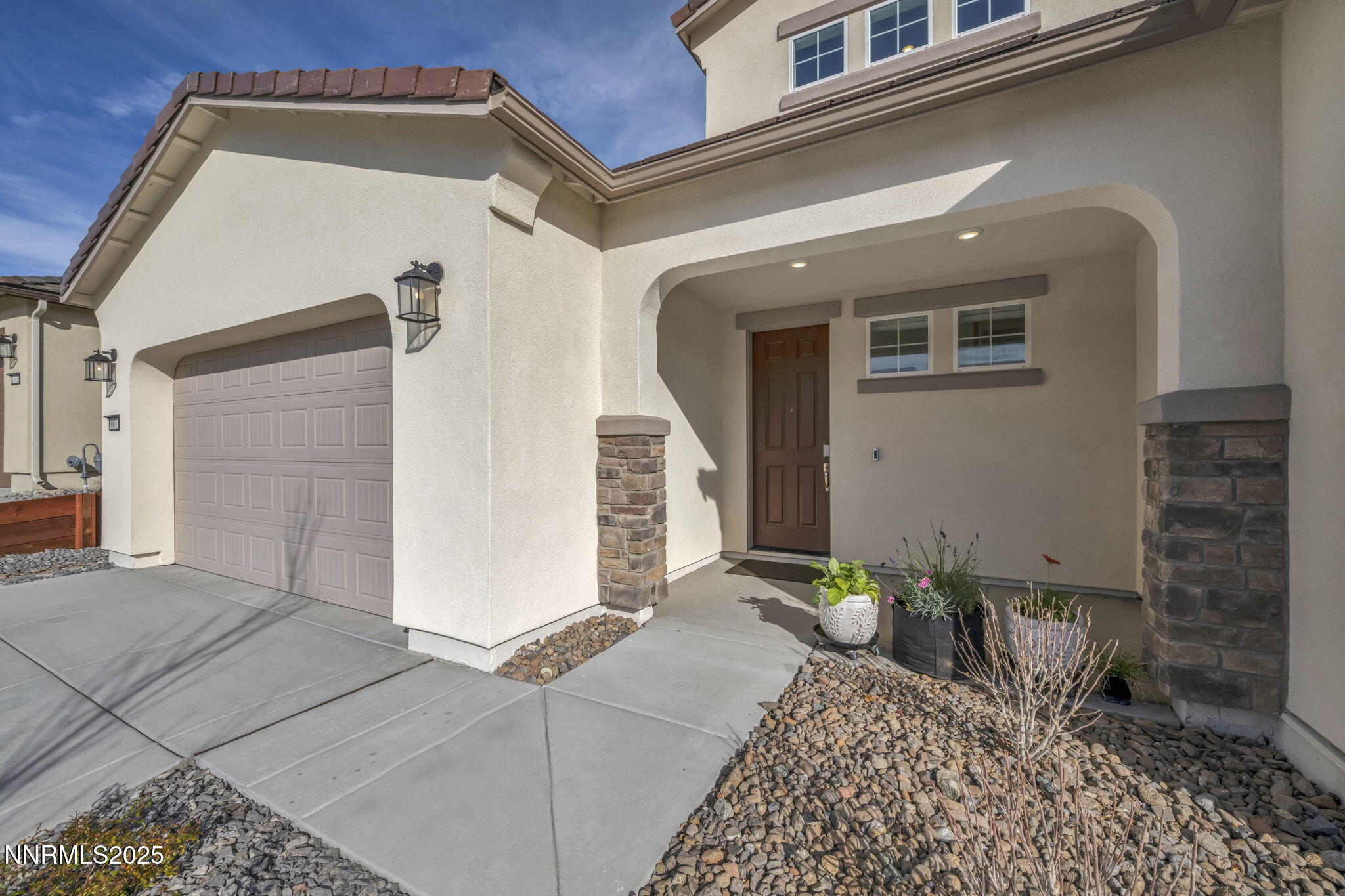 6870 Pilot Peak Road Sparks, NV 89436 - Photo 2 of 55 front view of a house with a potted plant