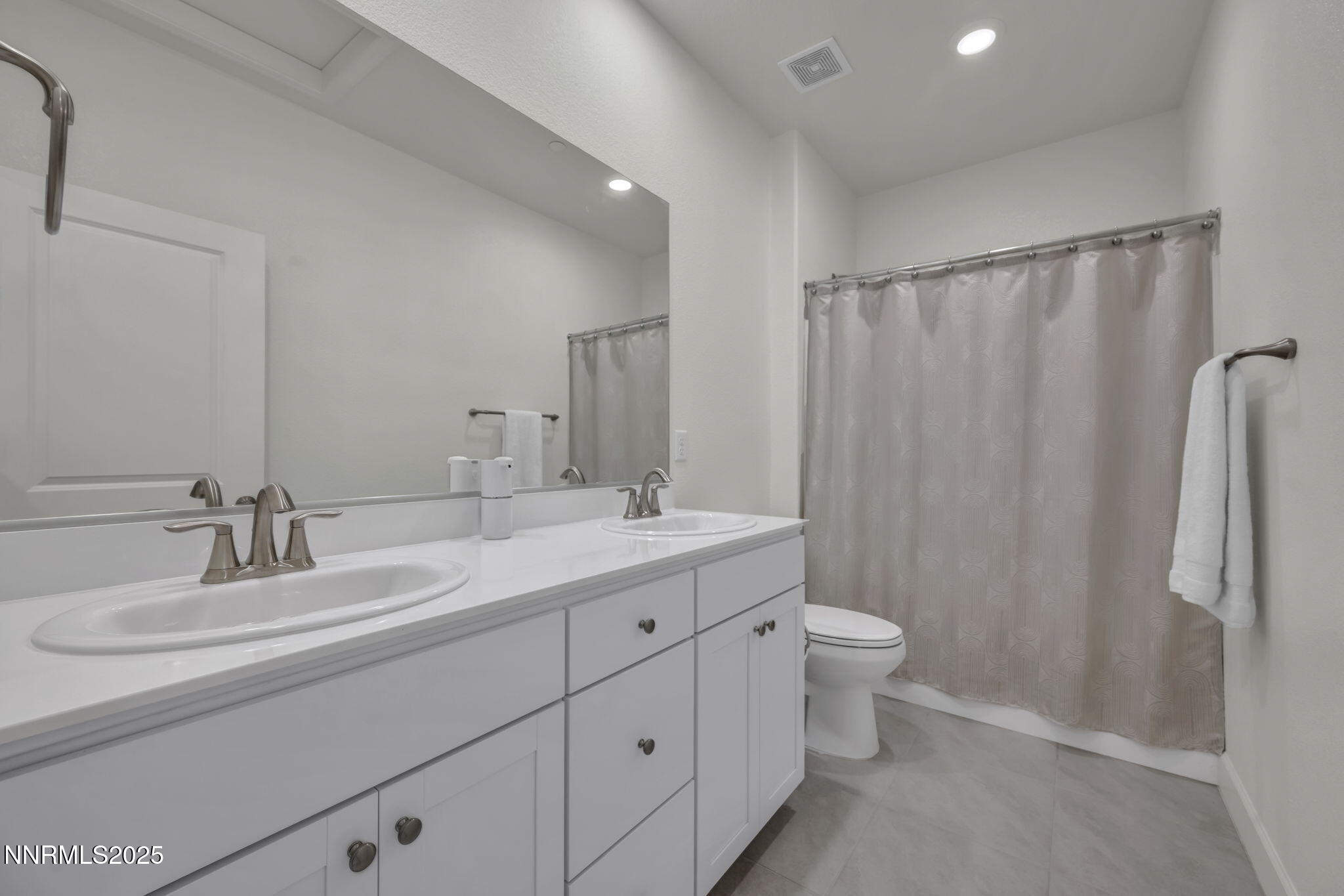 6870 Pilot Peak Road Sparks, NV 89436 - Photo 38 of 55 a bathroom with a double vanity sink toilet and a mirror