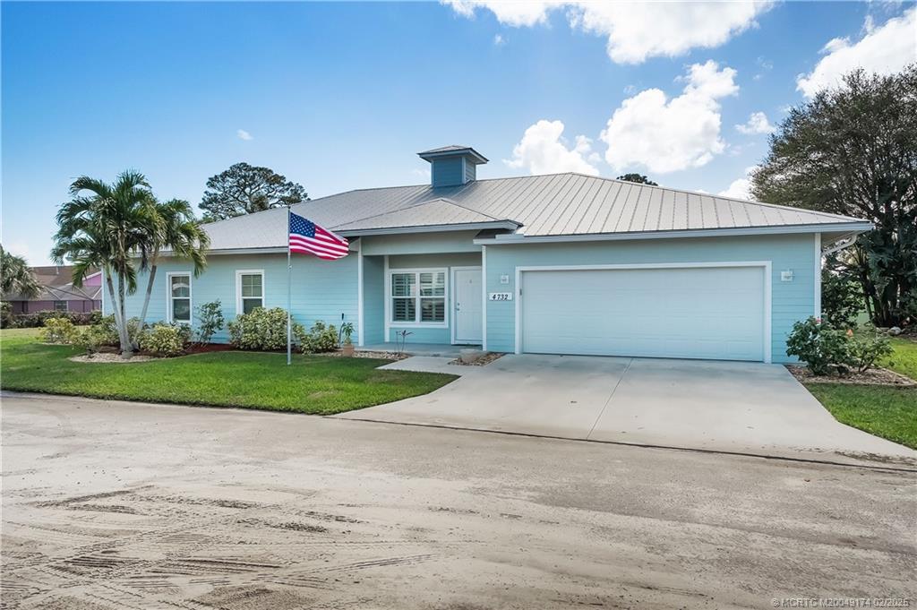 4732 Starling Way Stuart, FL 34997 - Photo 1 of 43 a front view of a house with a yard and a garage