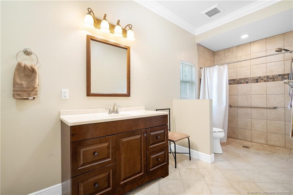 4732 Starling Way Stuart, FL 34997 - Photo 24 of 43 a bathroom with a sink and a mirror