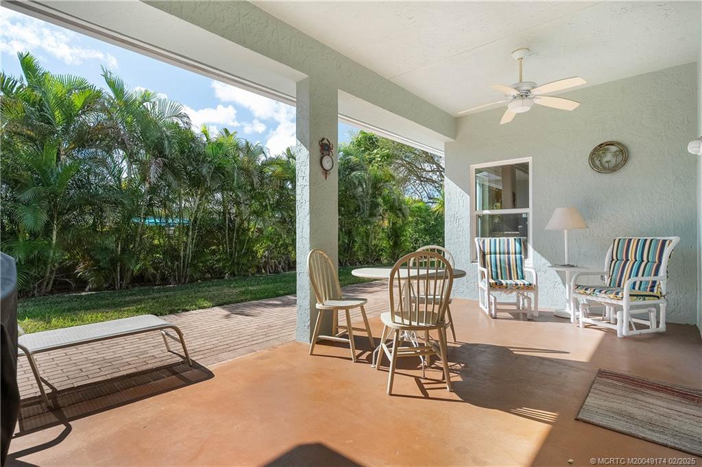 4732 Starling Way Stuart, FL 34997 - Photo 31 of 43 a view of a patio with a table chairs and backyard