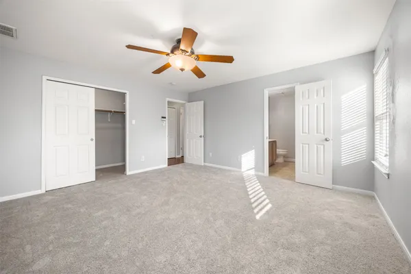 a view of a livingroom with a ceiling fan and window