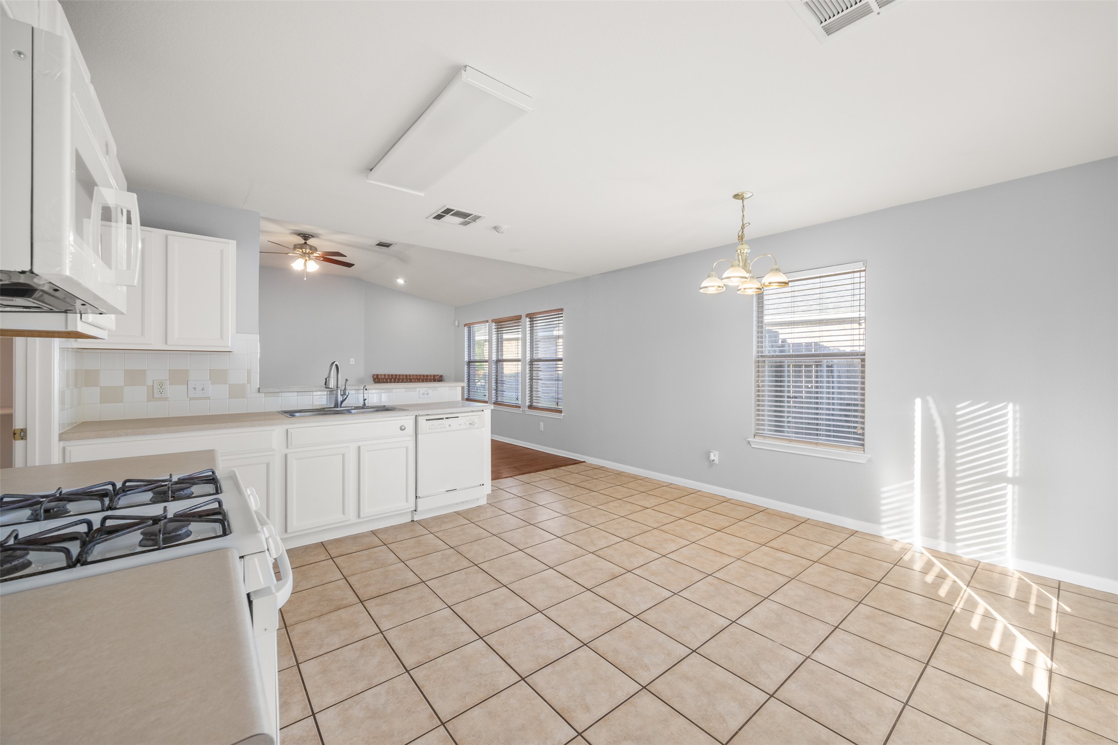 121 Primrose Boulevard Kyle, TX 78640 - Photo 18 of 19 a kitchen with stainless steel appliances granite countertop a sink and a stove