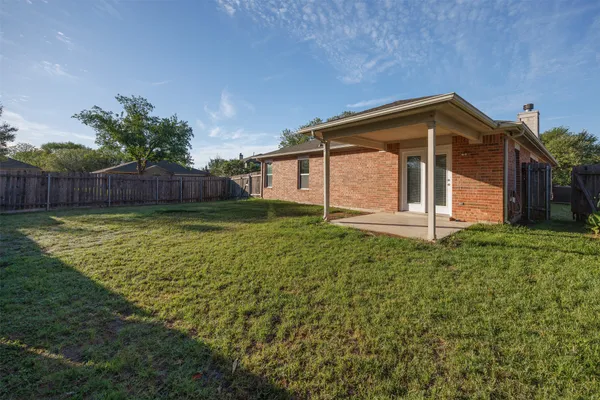 a view of a kitchen with a sink and dishwasher with wooden floor