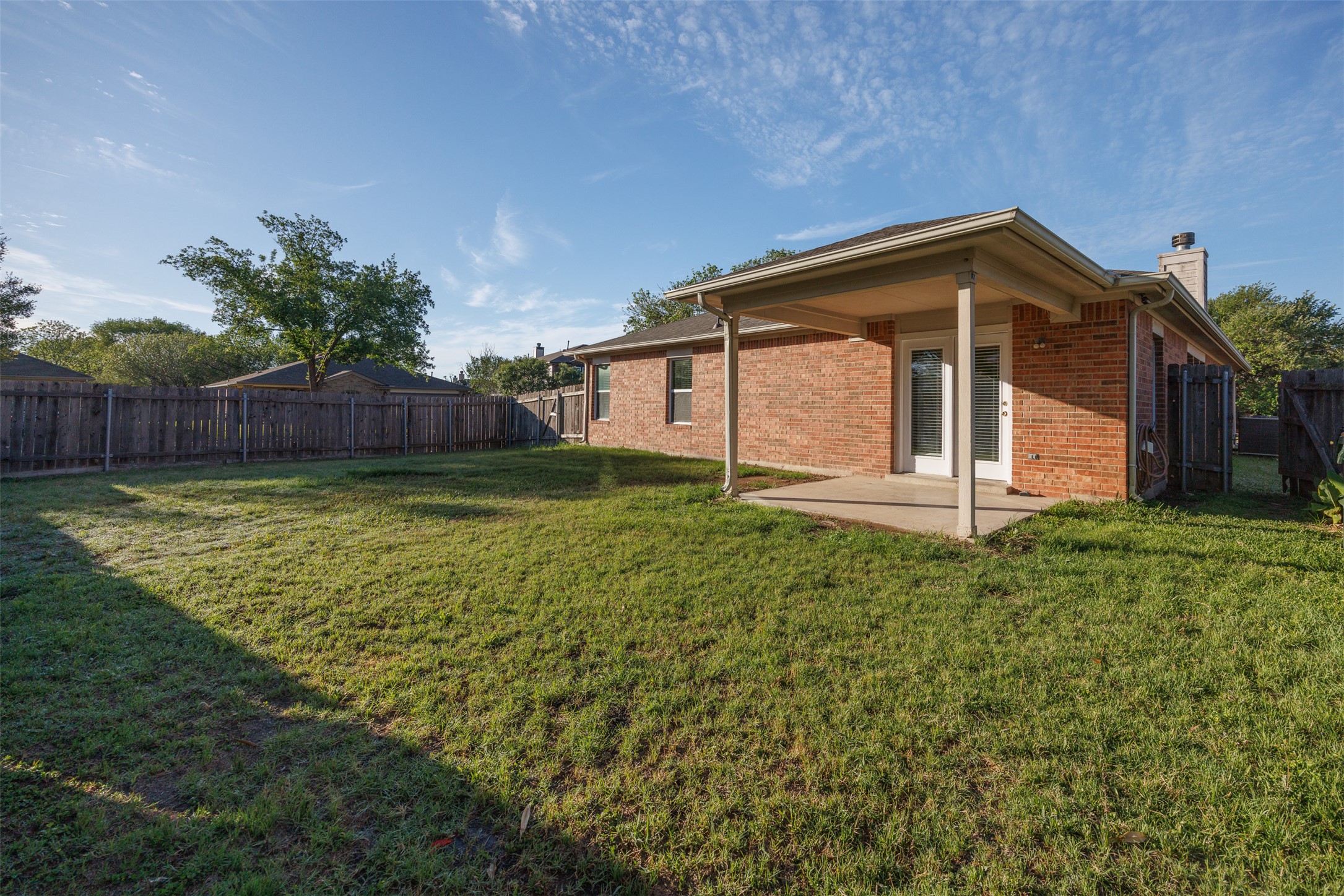 121 Primrose Boulevard Kyle, TX 78640 - Photo 16 of 19 a view of a house with a yard
