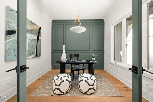 a view of a livingroom with wooden floor and a fireplace